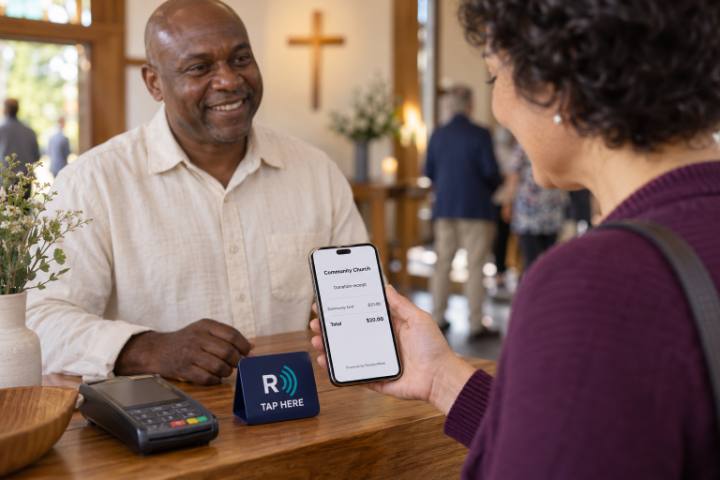 A congregation member views her ReceiptWave donation receipt at a church welcome desk