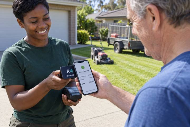 A homeowner views his ReceiptWave receipt after the lawn operator holds out the tap terminal